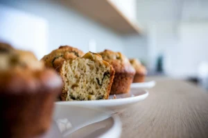 Freshly baked Banana Zucchini Muffins cooling on a wire rack.